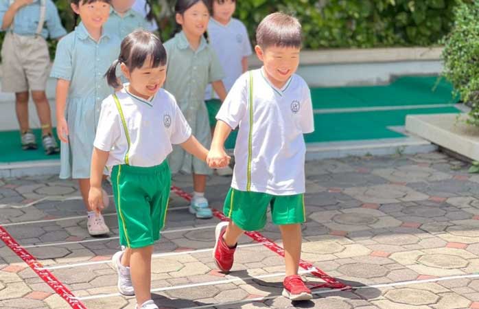 Child smiling and talking with a teacher