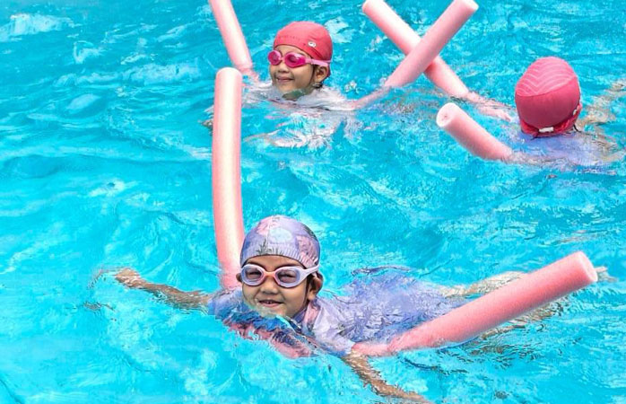 Children enjoying activities in the swimming pool